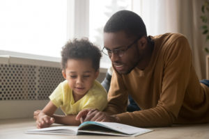 father and son reading together